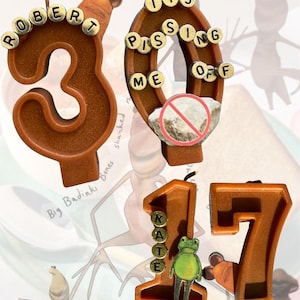 May include: Brown birthday candles shaped as numbers 30 and 17, with the name "Robert" on the 3 and "Kate" on the 1. The zero candle has the text "Its Pissing Me Off". A green frog is on the 1 candle. The background has ant illustrations.