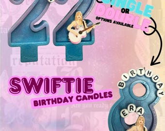 May include: Blue and purple birthday candles with the number 22 and the word "Swiftie". The candles have a singer playing a guitar. The text "I'm feelin" is on the top of the number 22. The text "Single or Double" is also visible.