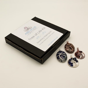 May include: A black square box labeled Abby Hook Jewellery Tree of Life Kit Jewellery Making Kit Includes Materials & PDF tutorial www.abbyhook.co.uk with four wire-wrapped gemstone pendants featuring tree designs in blue, brown, and dark red tones.