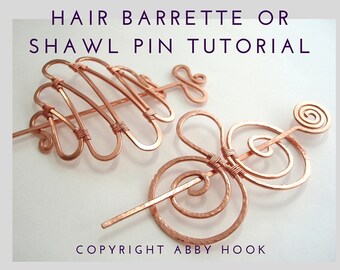 May include: Two copper wire hair barrettes or shawl pins. One is a simple, straight pin with a spiral at the top. The other is a more elaborate design with multiple loops and curves.  The text "HAIR BARRETTE OR SHAWL PIN TUTORIAL" and "COPYRIGHT ABBY HOOK" is visible in the image.
