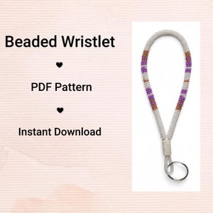 May include: A beaded wristlet featuring a white base, with purple and gold bead accents. It includes a silver-coloured key ring. The text reads "Beaded Wristlet", "PDF Pattern", and "Instant Download".