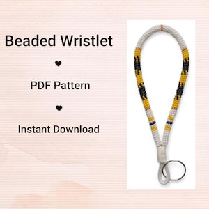 May include: A beaded wristlet with a white, black, and yellow pattern. The wristlet has a metal ring and a white fabric loop. Text on the left side reads "Beaded Wristlet", "PDF Pattern", and "Instant Download".