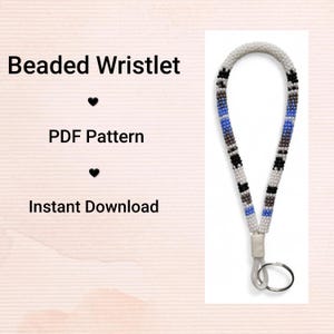 May include: A beaded wristlet with a white background. The wristlet is white with sections of black, gray, and blue beads. The wristlet has a key ring attached. Text on the left side reads "Beaded Wristlet", "PDF Pattern", and "Instant Download".