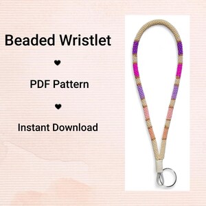 May include: A beaded wristlet featuring a pattern of purple, pink, and beige beads. The wristlet is connected to a metal ring. Text on the left side says "Beaded Wristlet", "PDF Pattern", and "Instant Download".