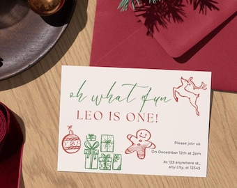 May include: A white card with green and red illustrations of Christmas ornaments, a gingerbread man, and a reindeer. The text on the card reads "oh what fun LEO IS ONE!" and includes details for a party on December 12th at 2pm.