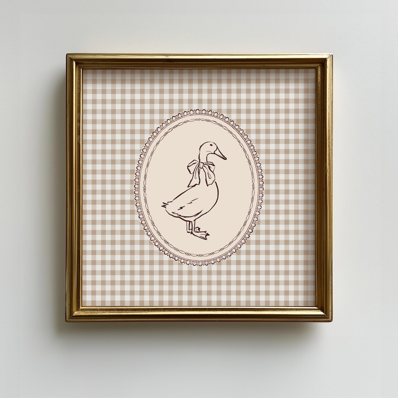 This vintage-inspired digital art print features a hand drawn duck with bow illustration and a neutral beige brown gingham background. This square print make the perfect gift for wall decor for a vintage cottage and elegant nursery room for a baby girl or boy, bedroom or even the kids game room.