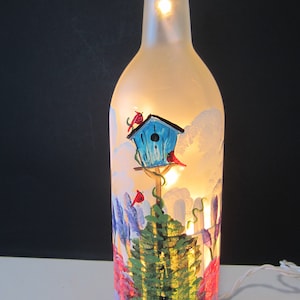 GARDEN SCENE with a White Picket Fence , Flowers, Bird House, Cardinals on a  Frosted Lighted Wine Bottle **Electric Lights**