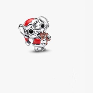 May include: A silver charm featuring the character Stitch from Lilo & Stitch, dressed in a Santa hat and red outfit, holding a gingerbread man. The charm is detailed with black eyes and a festive design, perfect for holiday-themed jewelry.