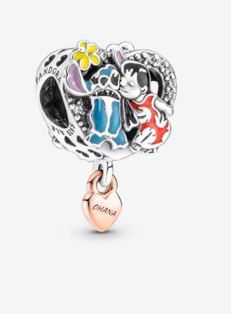 May include: A silver charm with a heart-shaped design featuring the characters Stitch and Lilo from the Disney movie Lilo & Stitch. The charm has a rose gold heart pendant that says "OHANA".
