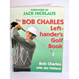 May include: The Bob Charles Left-hander's Golf Book, with a green and white cover, features a photo of Bob Charles swinging a golf club. The book's title is in large red letters, with the author's name and the foreword by Jack Nicklaus.