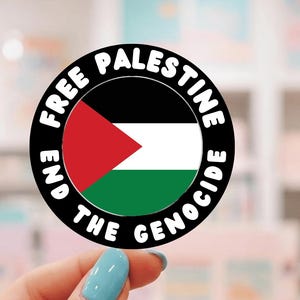 May include: A round sticker featuring the Palestinian flag with a red triangle, black, white, and green stripes. The text "FREE PALESTINE" and "END THE GENOCIDE" are in a black ring around the flag.