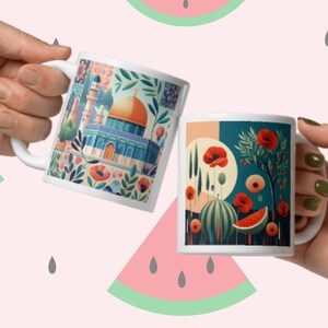 May include: Two white ceramic mugs with colorful illustrations. One mug features a mosque with a golden dome and floral designs. The other mug features a red poppy flower and a watermelon slice.