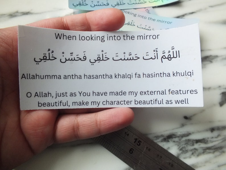May include: A white card with black text that reads "When looking into the mirror" and an Arabic phrase. The Arabic phrase translates to "O Allah, just as You have made my external features beautiful, make my character beautiful as well."