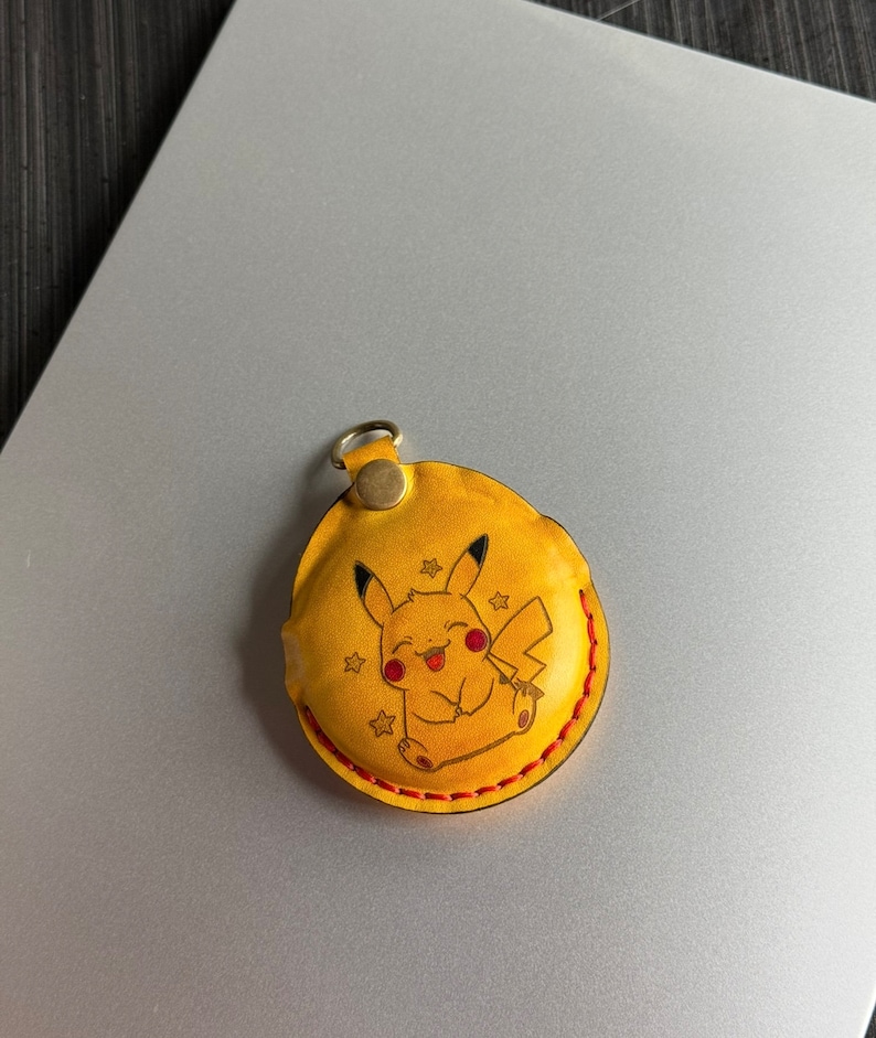Yellow dyed leather with painted character/logo option on Go Plus+ Sleeve. perfect for fans of Pokemon.
