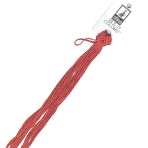 May include: A skein of red embroidery floss with a white label that reads "SILK N COLORS™" and a small illustration of a person.