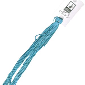 May include: A skein of light blue embroidery floss with a white label that reads "SILK 'N COLORS" and features a small image of a bird.