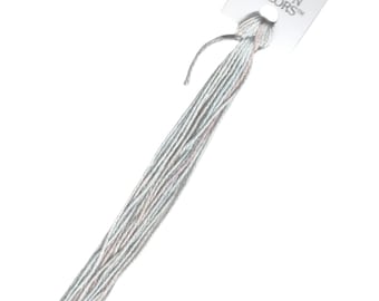 May include: A skein of light blue embroidery floss with a white and pink shimmer. The floss is labeled "SILK 'N COLORS" on a white tag.