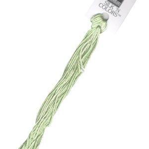May include: A skein of light green embroidery floss with a white label that reads "SILK 'N COLORS" and features a small image of a woman in a dress.