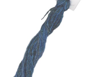 May include: A skein of blue and green metallic embroidery floss with a white tag that reads "The Thread Shed Aurora".