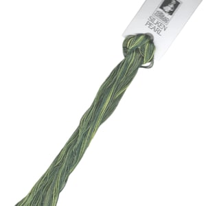 May include: A skein of green and yellow embroidery floss with a white label that reads "Thea-Goode Silken Pearl".