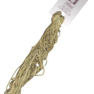 May include: A skein of gold-colored chenille yarn with a white label that reads "DMC Silken Chenille".
