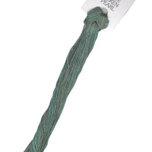 May include: A skein of DMC Silken Pearl embroidery floss in a teal green color. The floss is tied with a knot and attached to a white card with the DMC logo and the words "Silken Pearl".