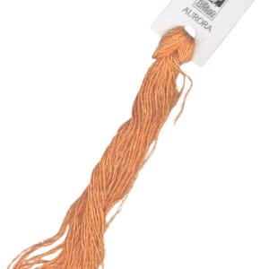 May include: A skein of orange embroidery floss with a white label that reads "AURORA" and a small image of a woman with a bird.