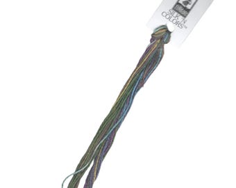 May include: A skein of multi-colored embroidery floss in shades of green, blue, purple, and gold. The floss is labeled "SILK N COLORS" on a white tag.