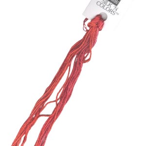 May include: A skein of red embroidery floss with a white label that reads "Thea Gouverneur Silk 'N Colors™".