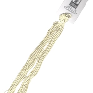 May include: A skein of off-white embroidery floss with a label that reads "Silk 'n Colors".