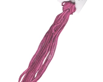 May include: A skein of pink embroidery floss with a white tag that reads "SILK 'N COLORS" and features a small image of a bird.