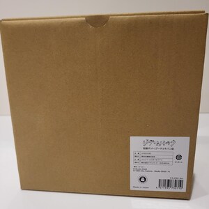 May include: A brown cardboard box with a white label and Japanese text. The box has a curved cutout on the top. The label includes the text "ジブリパーク" and a barcode.