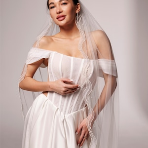 Elegant Wedding veil with pearl trim. This single-tier veil is decorated with high-quality pearls of various sizes . image 7