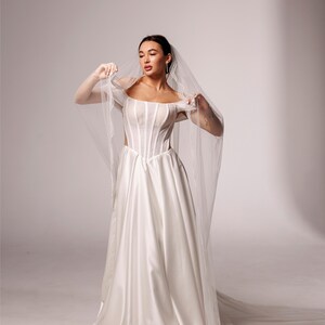 Elegant Wedding veil with pearl trim. This single-tier veil is decorated with high-quality pearls of various sizes . image 14