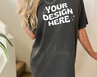 May include: A dark gray oversized t-shirt with short sleeves and a crew neck. The shirt has the text "YOUR DESIGN HERE" printed in white with small stars around the text.