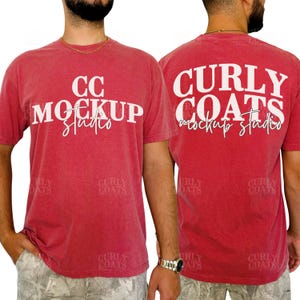 May include: Red t-shirts with white text. The front of the shirt reads "CC MOCKUP studio" and the back reads "CURLY COATS mockup studio". The shirts are short-sleeved and have a crew neck.