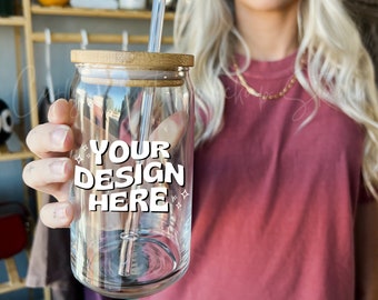 May include: A clear glass tumbler with a bamboo lid and a straw. The tumbler has the text "YOUR DESIGN HERE" printed on it.