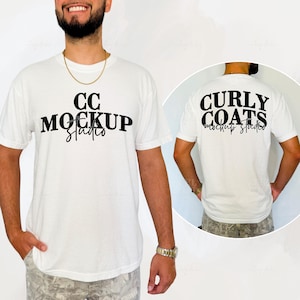 May include: White t-shirt with the text "CC Mockup Studio" on the front and "Curly Coats Mockup Studio" on the back. The t-shirt is being modeled by a person.