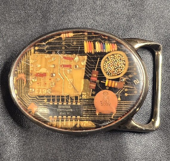 A belt buckle made from a real upcycled PCB circuit board — wearable e-waste art that's equal parts steampunk, cyberpunk, and conversation starter.