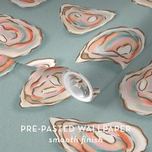 May include: Pre-pasted wallpaper with a smooth finish, featuring a repeating pattern of watercolor oyster shells in shades of pink, orange, blue, and brown on a light teal background. The text "PRE-PASTED WALLPAPER smooth finish" is visible.