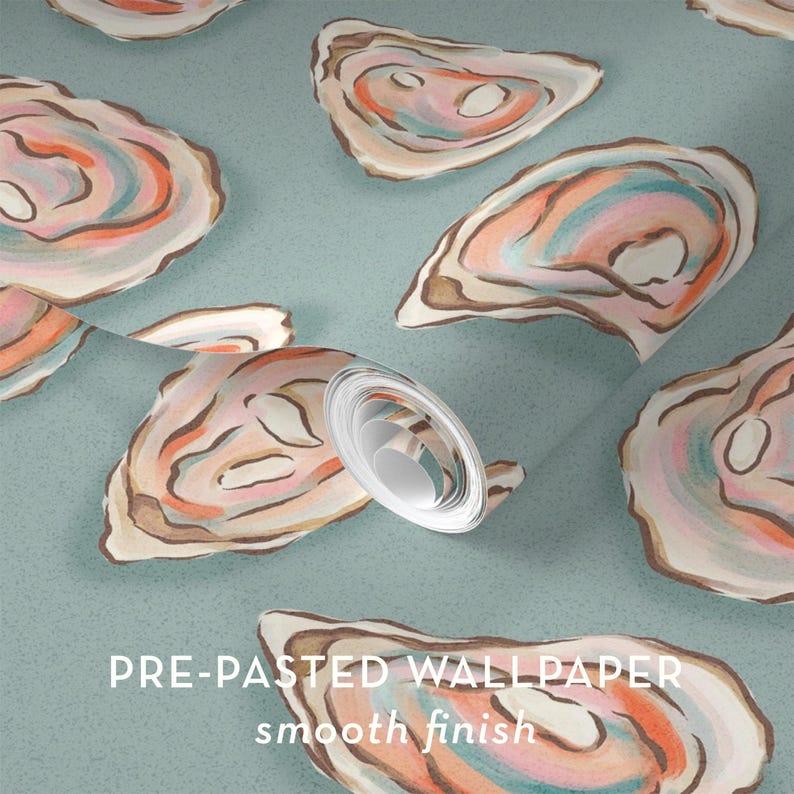 May include: Pre-pasted wallpaper with a smooth finish, featuring a repeating pattern of watercolor oyster shells in shades of pink, orange, blue, and brown on a light teal background. The text "PRE-PASTED WALLPAPER smooth finish" is visible.