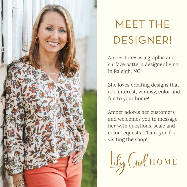 May include: A smiling woman wearing a floral print blouse and orange pants. The text reads "MEET THE DESIGNER!" and introduces Amber Jones, a graphic and surface pattern designer. The shop name "Lily Girl HOME" is also displayed.