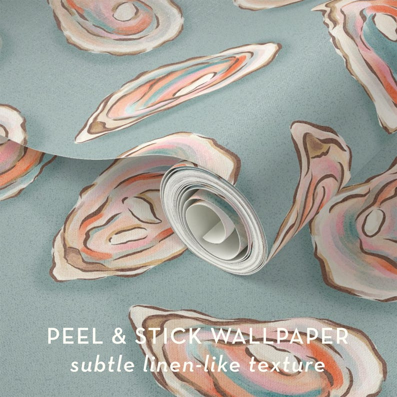 May include: A roll of peel and stick wallpaper with a subtle linen-like texture. The wallpaper features a repeating pattern of watercolor oyster shells in shades of pink, orange, and brown on a light blue background.