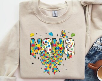 Bluza z nadrukiem "Autism Mama" z motywem świadomości autyzmu, kokieterią, kokardką dla mamy autyzmu, koszulką z motywem orędownika autyzmu, edukacją specjalną, neuroróżnorodnością, puzzlami