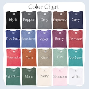 May include: A color chart displays a variety of t-shirt colors. The shirts are arranged in rows and columns, showcasing shades like black, navy, violet, crimson, and seafoam. The text "Color Chart" is at the top.
