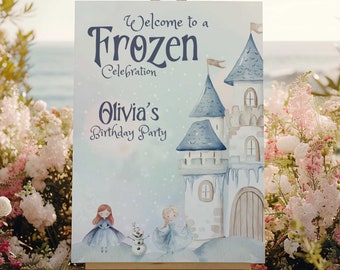 May include: A welcome sign for a Frozen themed birthday party. The sign features a blue and white castle with a snowy background. The text on the sign reads "Welcome to a Frozen Celebration Olivia's Birthday Party".