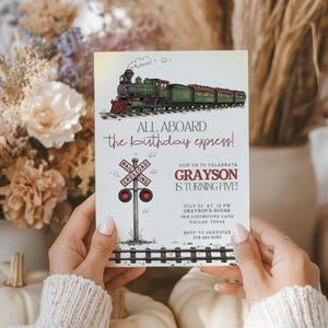 May include: A birthday party invitation featuring a vintage train illustration. The text reads "ALL ABOARD the birthday express!" and "GRAYSON IS TURNING FIVE!" Includes railroad crossing sign and event details.