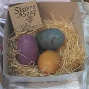 Three egg soaps in a nest image 1