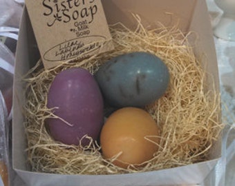 Three egg soaps in a nest