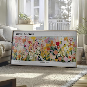 May include: A framed art print displaying a vibrant floral artwork in pinks, yellows, oranges, and reds. The print includes the text "HENRI MATISSE" and "HISTORY OF FRENCH ART & DESIGN". Additional text reads "ART POSTER" and "SOUTH KENSINGTON".